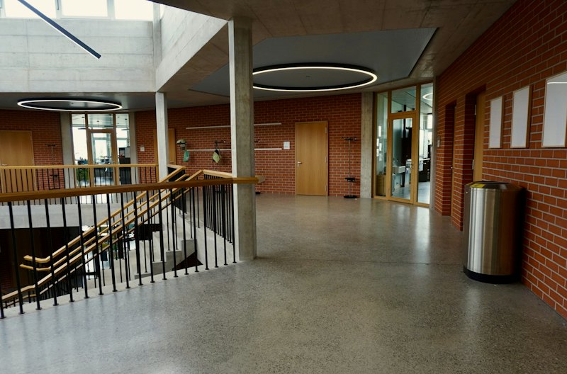 Bright hallway with a speckled, terrazzo-style flake floor